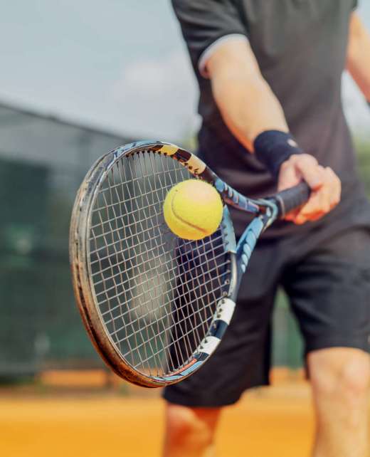 Close,Up,Of,Man,Playing,Tennis,And,Beating,The,Ball
